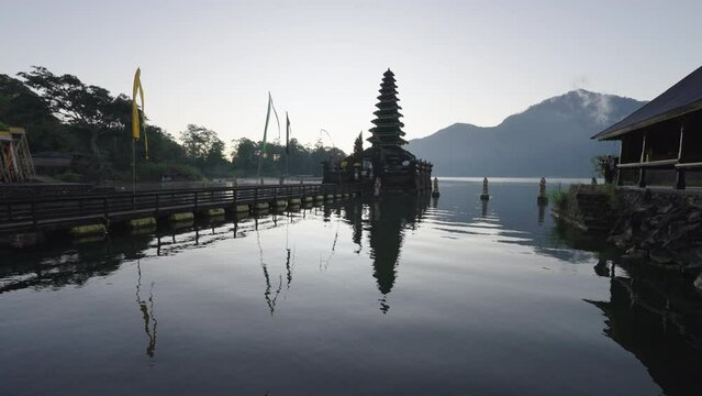 Lockdown Reflection Of Pura Jati Batur In Lake Against Clear Sky - Bali, Indonesia