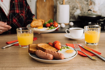 Cooked English breakfast with coffee and orange juice in the kitchen at home
