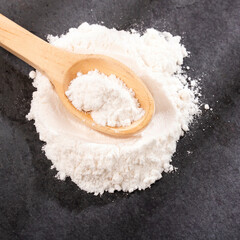 Sodium hydrogen carbonate - White baking soda in wooden spoon