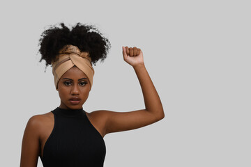 raised and closed hand gestures of a woman, black hair of power