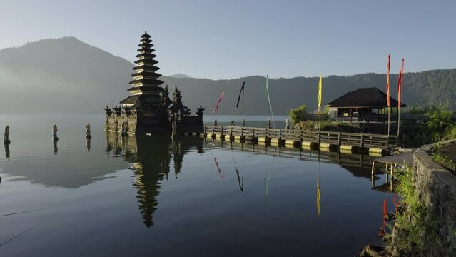 Reflection Of Pura Jati Batur Temple In Lake Against Clear Sky - Bali, Indonesia