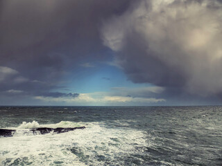 Stunning Irish seascape with rough stone coast line and powerful Atlantic ocean. Kilkee area, Ireland. Dramatic sky. Detailed nature scene. Popular travel and sightseeing area
