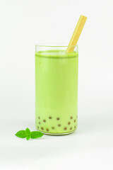 Bubble tea drink on light background. Homemade green matcha bubble tea with pearls in tall glasses with straws
