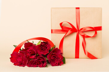 Valentines day red roses with gift box on color table