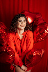 Portrait of beautiful woman with red balloon heart