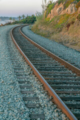 La Jolla, California- Curved railway near the mountain wall and beach. Train tracks near the...