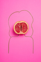 a grapefruit, grapefruit on a pink background and the silhouette of a drawn woman, concept of female health, healthy vagina
