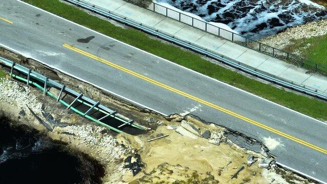 Aerial view of damaged road after flood water washed away asphalt. Rebuilding of ruined transportation infrastructure