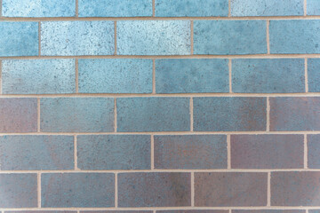 Smooth colored concrete blocks wall at Austin, Texas. Close-up of smooth glossy blocks with running bond pattern of the building exterior.