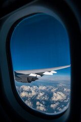 flying and traveling. Airplane interior or jet window with clouds and sky. Sky view from a high angle on the plane. 