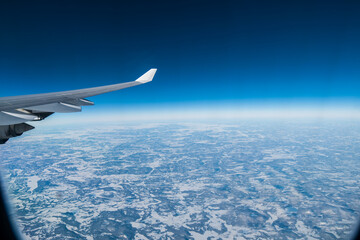 Fototapeta premium flying and traveling. Airplane interior or jet window with clouds and sky. Sky view from a high angle on the plane. 