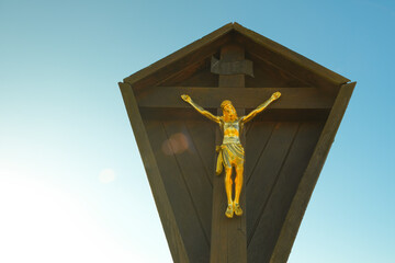 faith symbol. Jesus Christ on the wood cross on the blue sky with the rays of the sun. Christian...