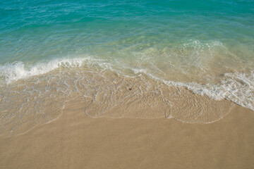 Beautiful Soft blue ocean wave on fine sandy beach. Blue ocean waves aerial drone shot on sandy beach. 