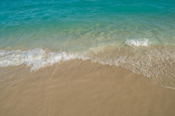 Fototapeta na wymiar Beautiful Soft blue ocean wave on fine sandy beach. Blue ocean waves aerial drone shot on sandy beach. 