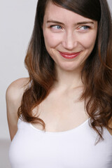 Close up studio portrait of cheerful attractive young woman.