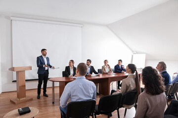 Business conference. People in meeting room listening to speaker report