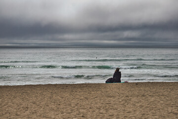 Solace on the Seashore: Woman Taking a Moment Looking Out to Pacific Ocean