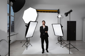 Handsome model posing in modern studio. Professional photo session