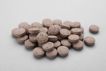 Brewer`s yeast tablets on light grey background, closeup