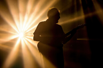 silhouette of a person with a guitar