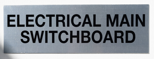 Electrical switchboard sign on wall