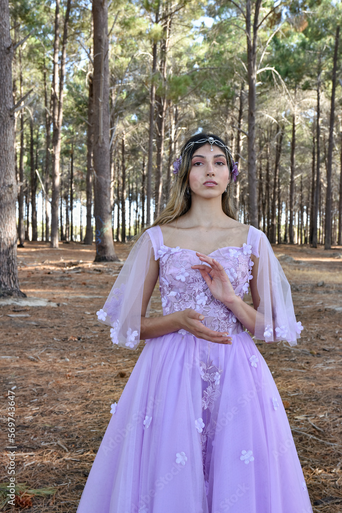 Wall mural close up portrait of beautiful young blonde model wearing a purple princess fantasy ball gown with f