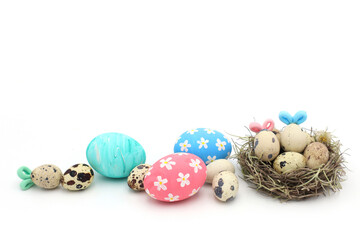 Colorful easter eggs and nest on white background
