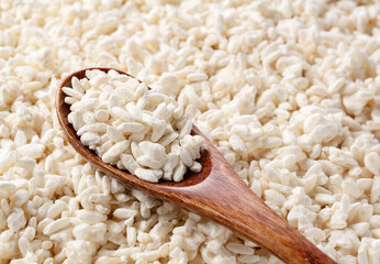 Close-up of rice koji and wooden spoon.