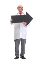 Mature doctor holding a black arrow pointing right isolated on white background