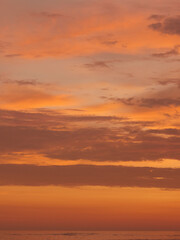  Sunset on the beach, golden hour, the sky is painted in orange and yellow colors