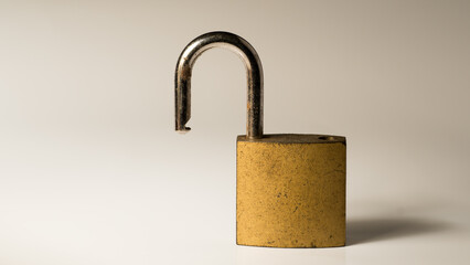 Opened golden padlock isolated on white background