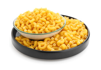 Plate of uncooked elbow pasta on white background