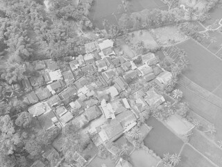 Black and white photo, Monochrome photo of aerial view of countryside on the edge of rice fields in Bandung city - Indonesia