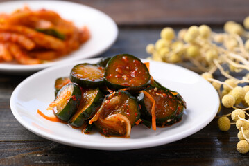 Kimchi cucumber and radish on wooden background, Korean food homemade side dish