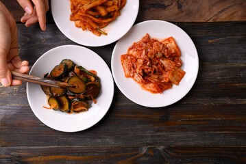 Kimchi cabbage, radish and cucumber ready to eating on wooden background, Korean food homemade side dish, Table top view