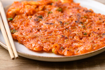 Kimchi pancake (Kimchi jeon or kimchi buchimgae) on plate, Korean food