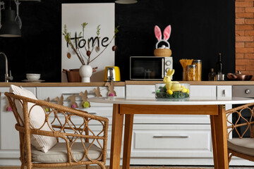 Interior of kitchen with Easter decor, counters and dining table