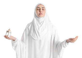 Praying Muslim woman with lantern on white background