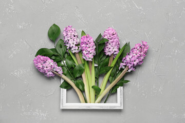 Composition with picture frame and hyacinth flowers on grunge background