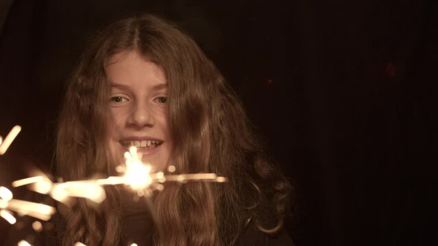 Girl Holding Sparklers And Shaking Her Head
