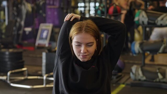 Young Woman Warming Up In Gym