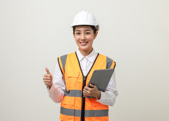 Asian engineer worker woman or architect with white safety helmet standing on isolated white background. Mechanic service factory Professional job occupation in uniform working with tablet