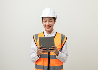 Asian engineer worker woman or architect with white safety helmet standing on isolated white background. Mechanic service factory Professional job occupation in uniform working with tablet