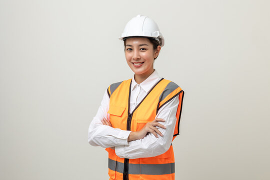 Asian engineer worker woman or architect with white safety helmet standing on isolated white background. Mechanic service factory Professional work job occupation in uniform.