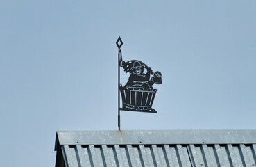 A weather vane on the roof of a rural house. Ryazan region. Russia