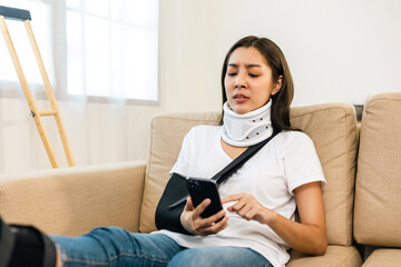 Woman stressed over medical expenses smartphone from accident fracture broken bone injury with leg...