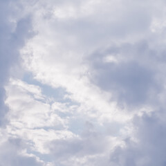 Cloudy sky background. Sunlight shining through white clouds.