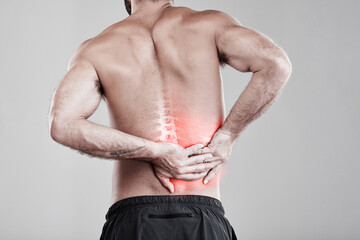 Man, hands and back pain in x ray for injury, bruise or spinal ache against a gray studio...