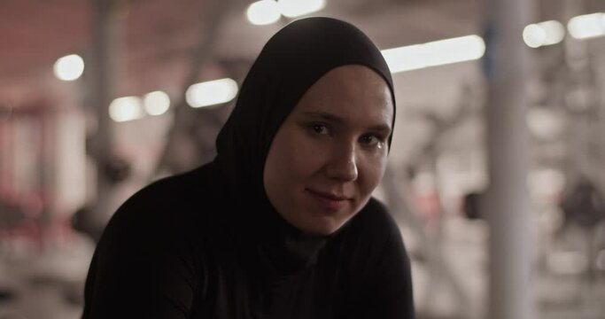 Sportswoman in hijab looking at camera