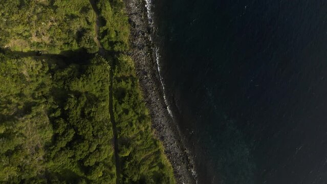 rural coastal village from above with crop fields, Lush green cliffs landscape over the Atlantic, Faj&atilde; dos Vimes, S&atilde;o Jorge island, the Azores, Portugal